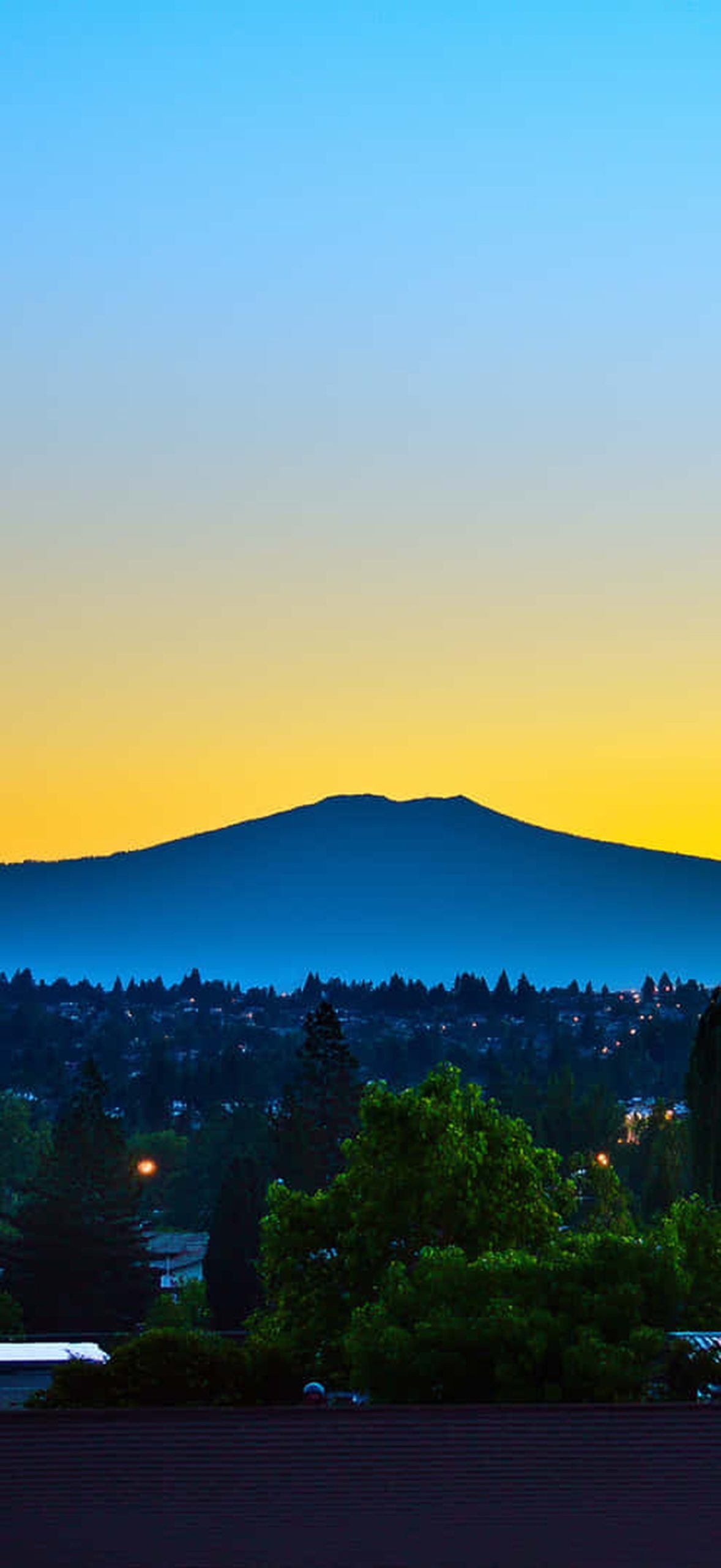 Horizon Silhouette with Vibrant Sky Over Distant Peaks