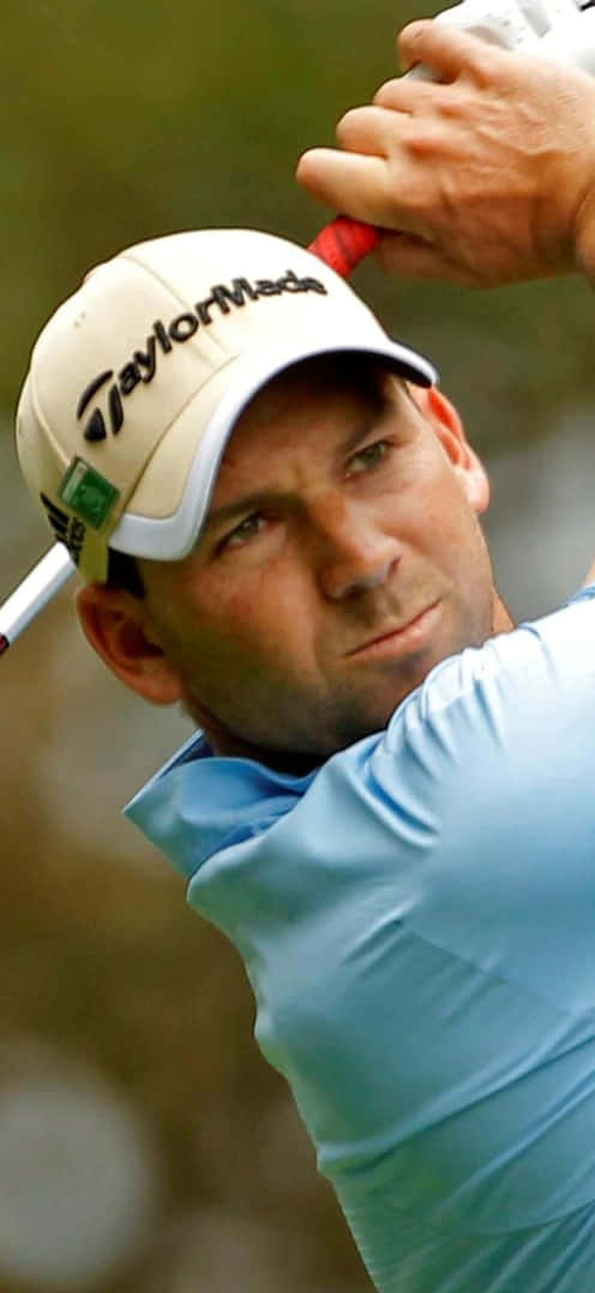 Professional golfer mid-swing on a sunny day