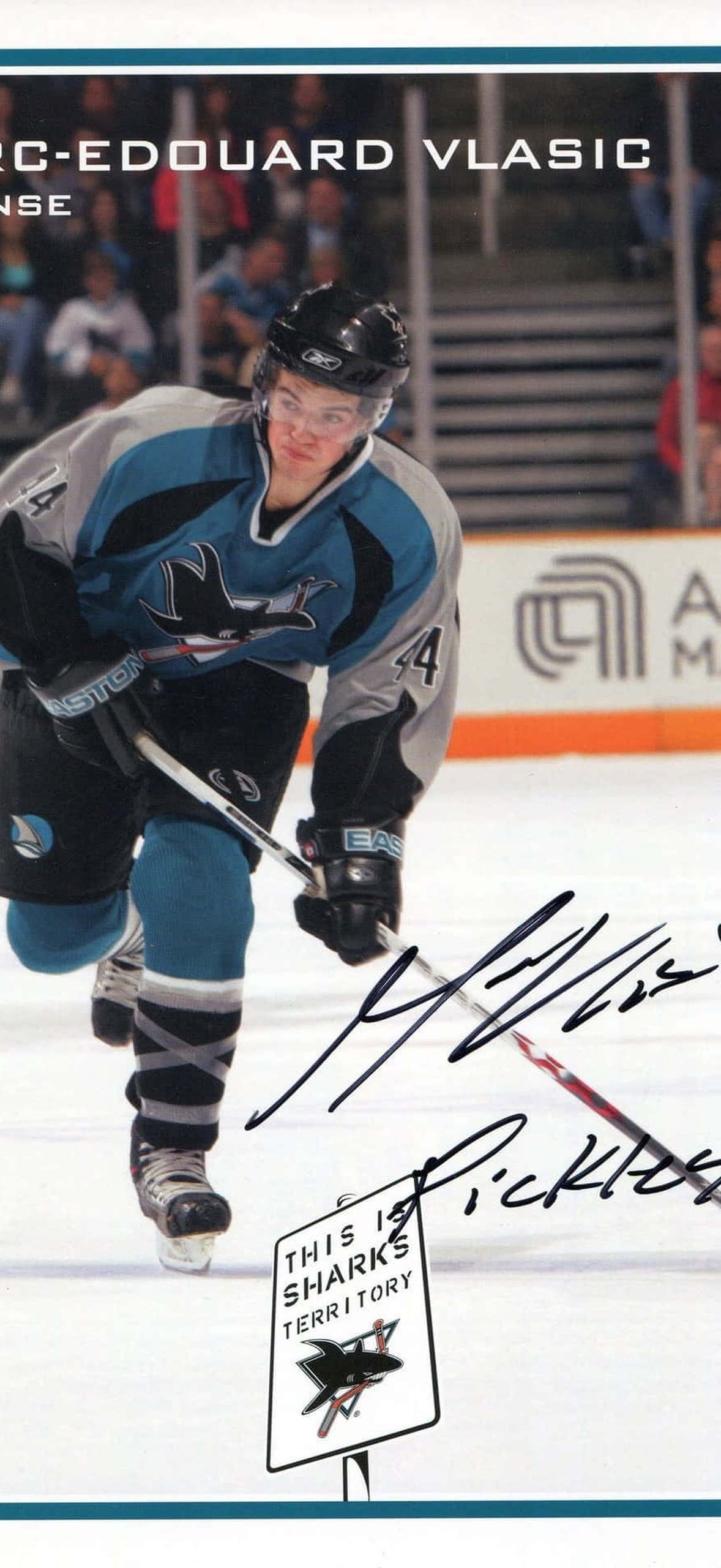 Hockey player Marc-Edouard Vlasic skating on ice during game with puck.