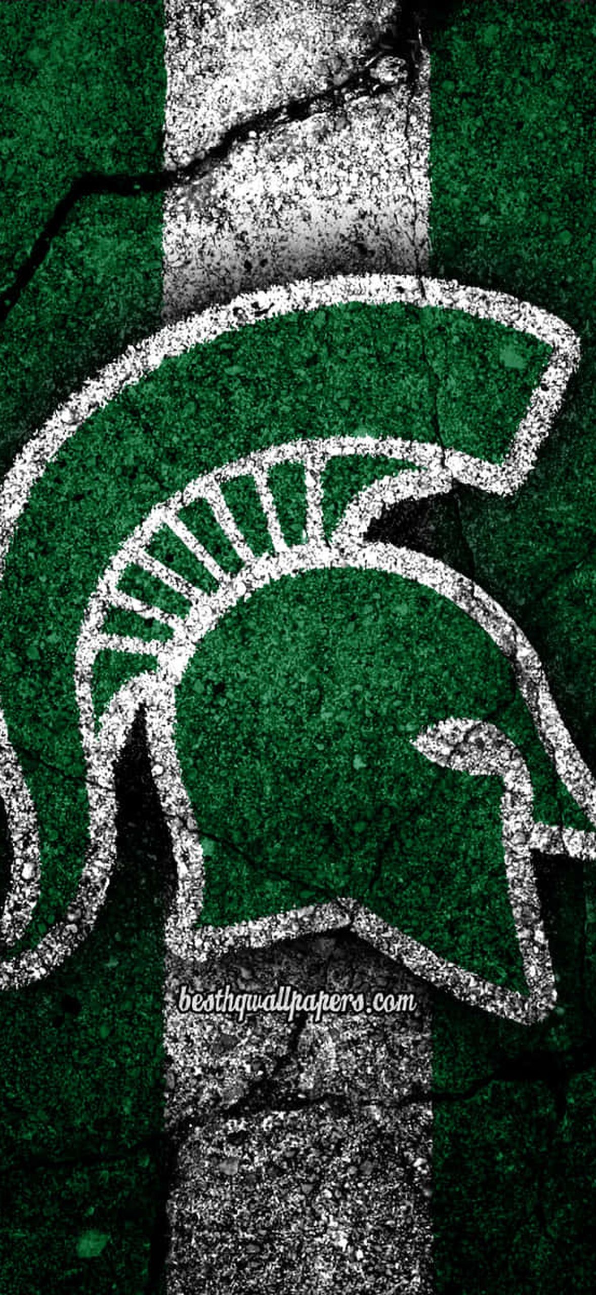 Spartan helmet logo painted on cracked asphalt surface.