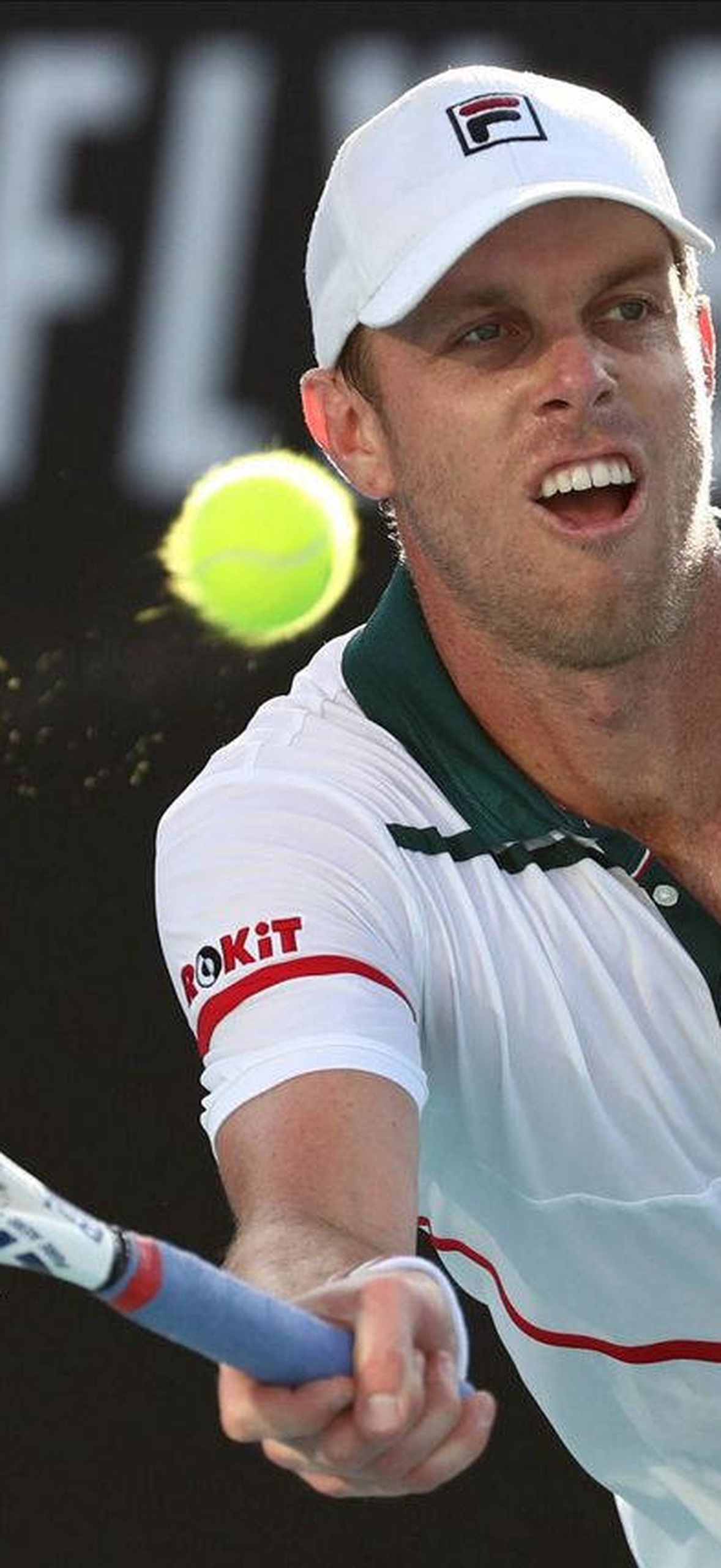 Tennis player hitting a ball with racket during match.